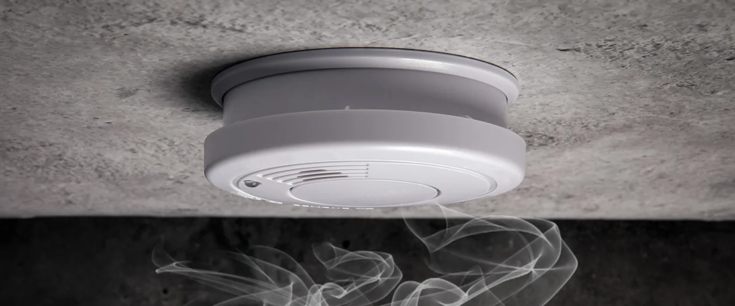Smoke alarm and smoke in the original website’s hero photograph